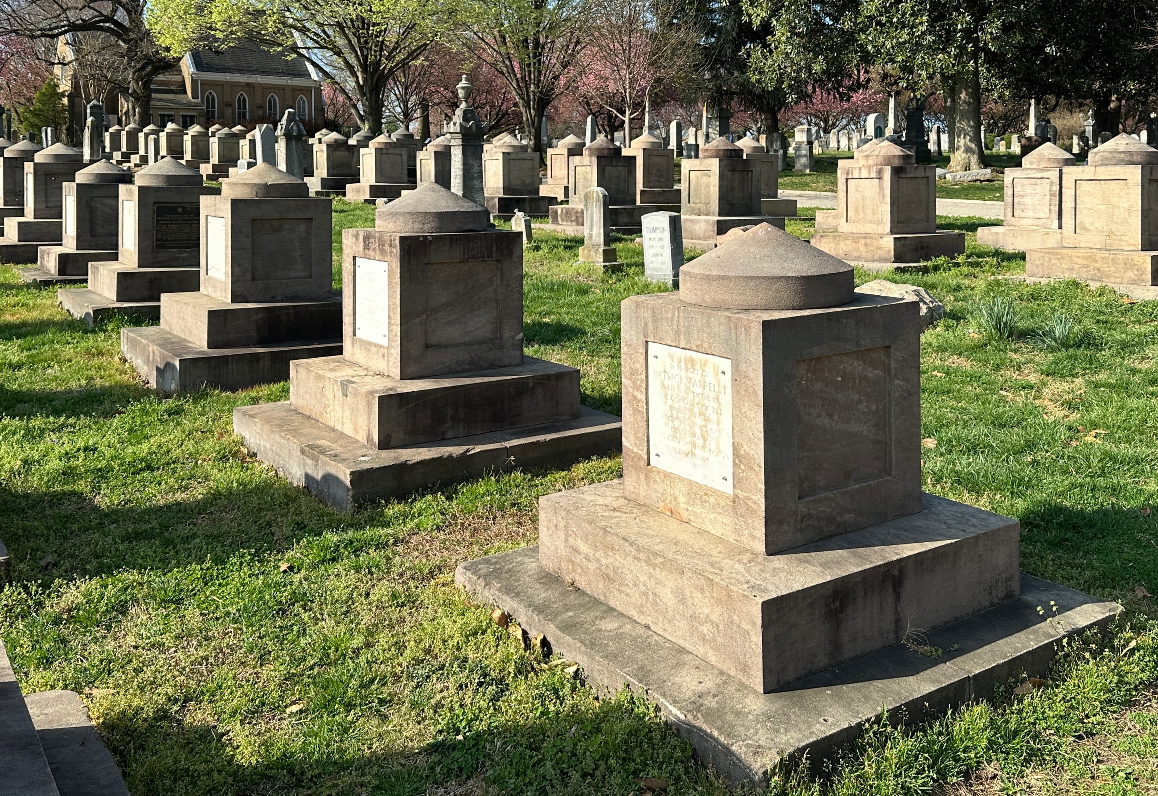 Rows of Latrobe cenotaphs — the identical Aquia Creek sandstone monuments for members of Congress — in Congressional Cemetery, Washington, DC