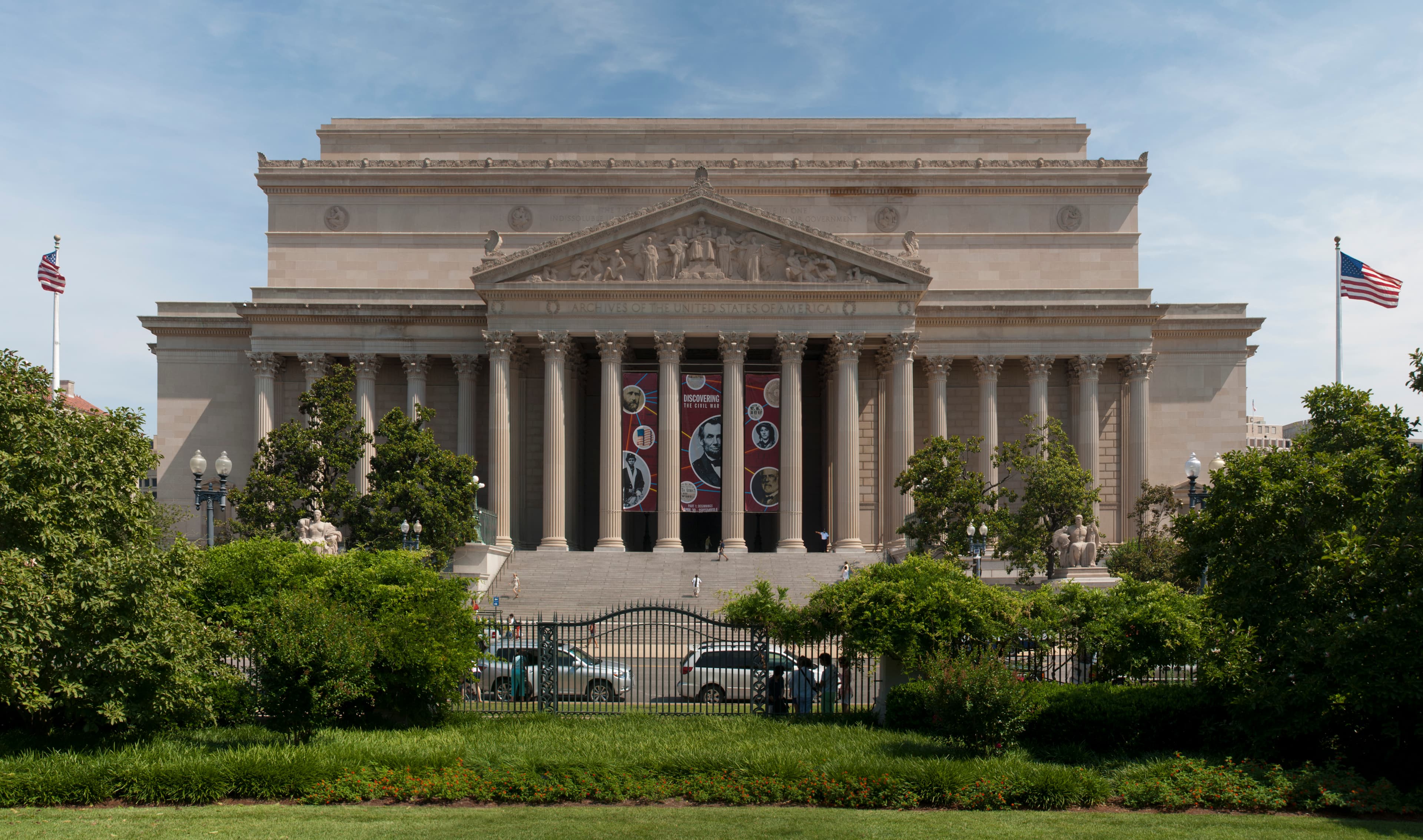 The National Archives Building in Washington, DC, its Corinthian colonnade and pediment facing the street.
