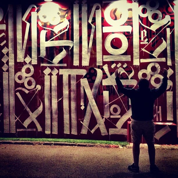 Photo: Ines Hegedus-Garcia, CC BY 2.0, via Wikimedia Commons. A mural by artist Retna at Wynwood Walls, photographed November 2012 — one of the early international contributors to the project.