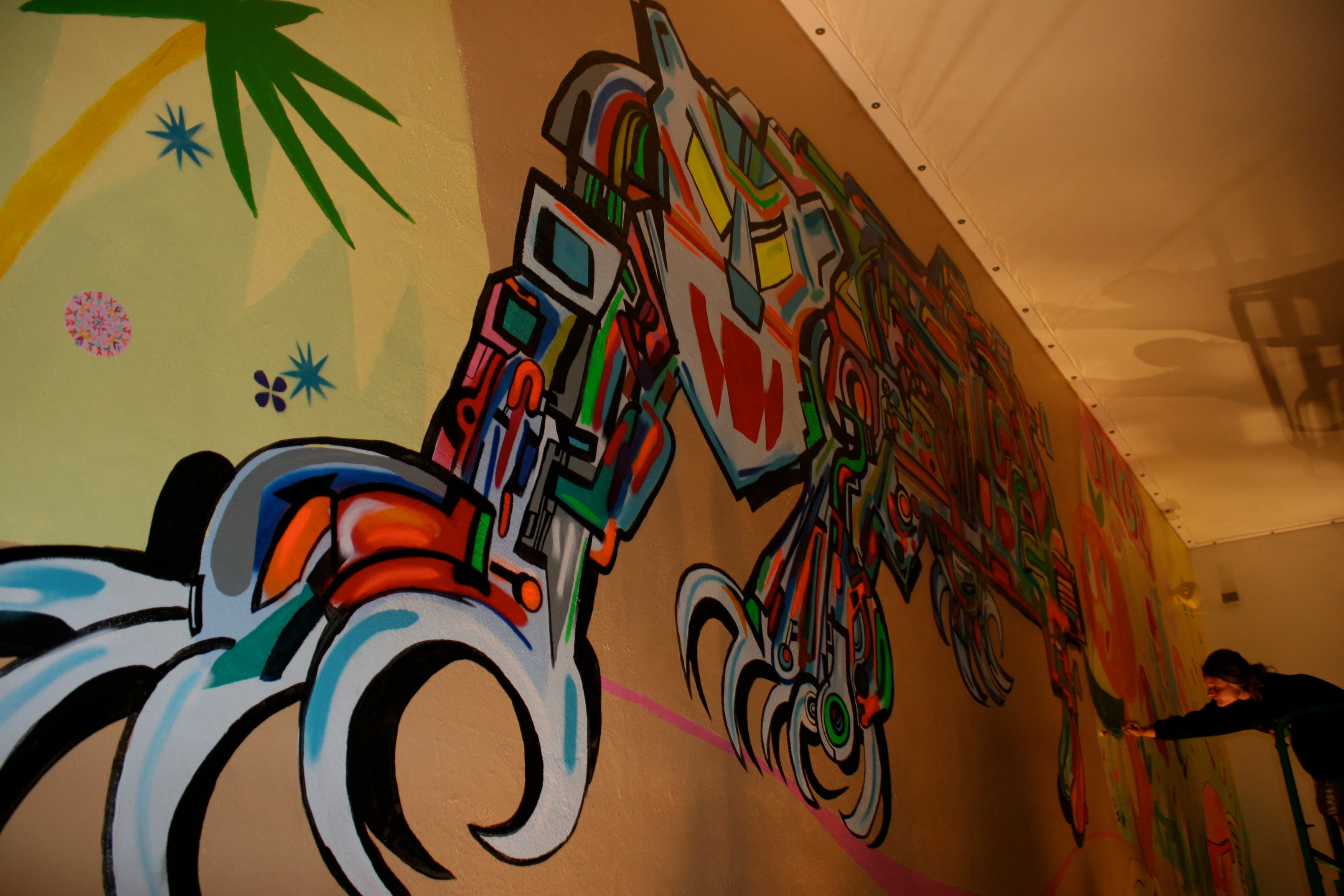 Photo: Sewperman, CC BY-SA 3.0, via Wikimedia Commons. A painted wall at Wynwood Walls, photographed December 2010 — from the project's early years, shortly after the Wynwood Doors were added.