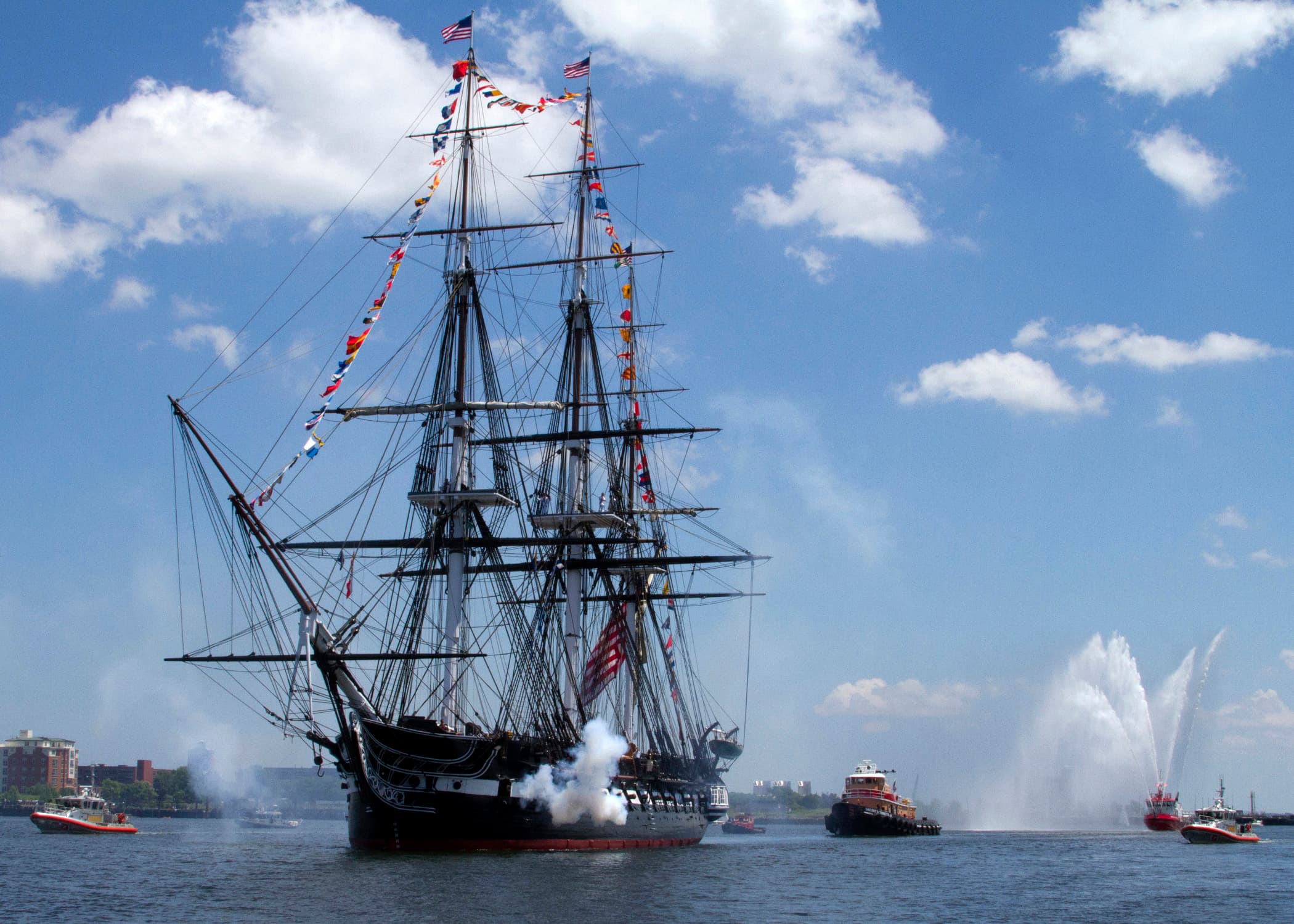 USS Constitution firing a 21-gun salute in Boston Harbor on July 4, 2013