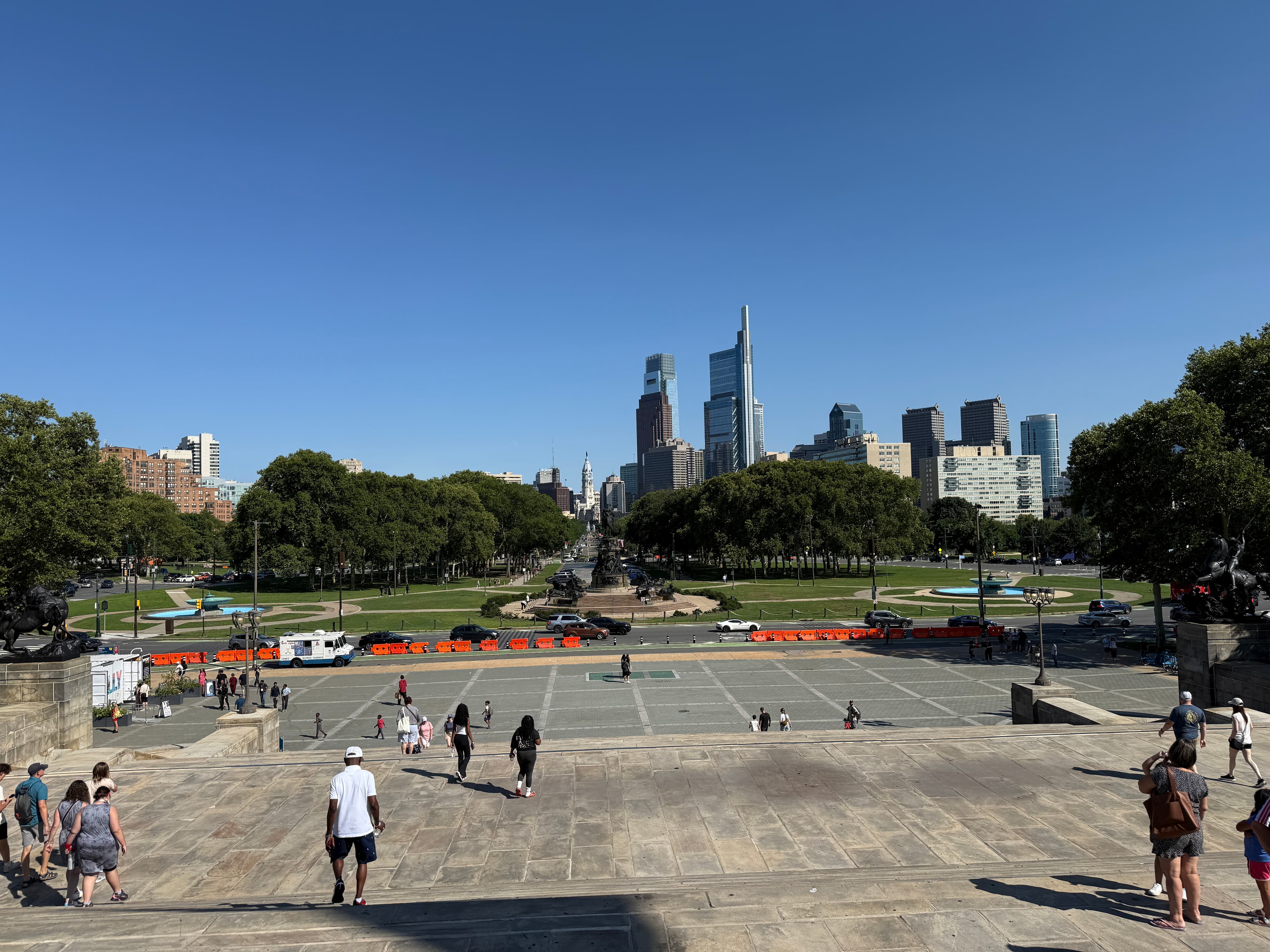Photo: Dough4872, CC BY-SA 4.0, via Wikimedia Commons. The view southeast down the Benjamin Franklin Parkway toward the Center City skyline, seen from the top of the museum's steps. (This is the view visitors see, not the steps themselves.)