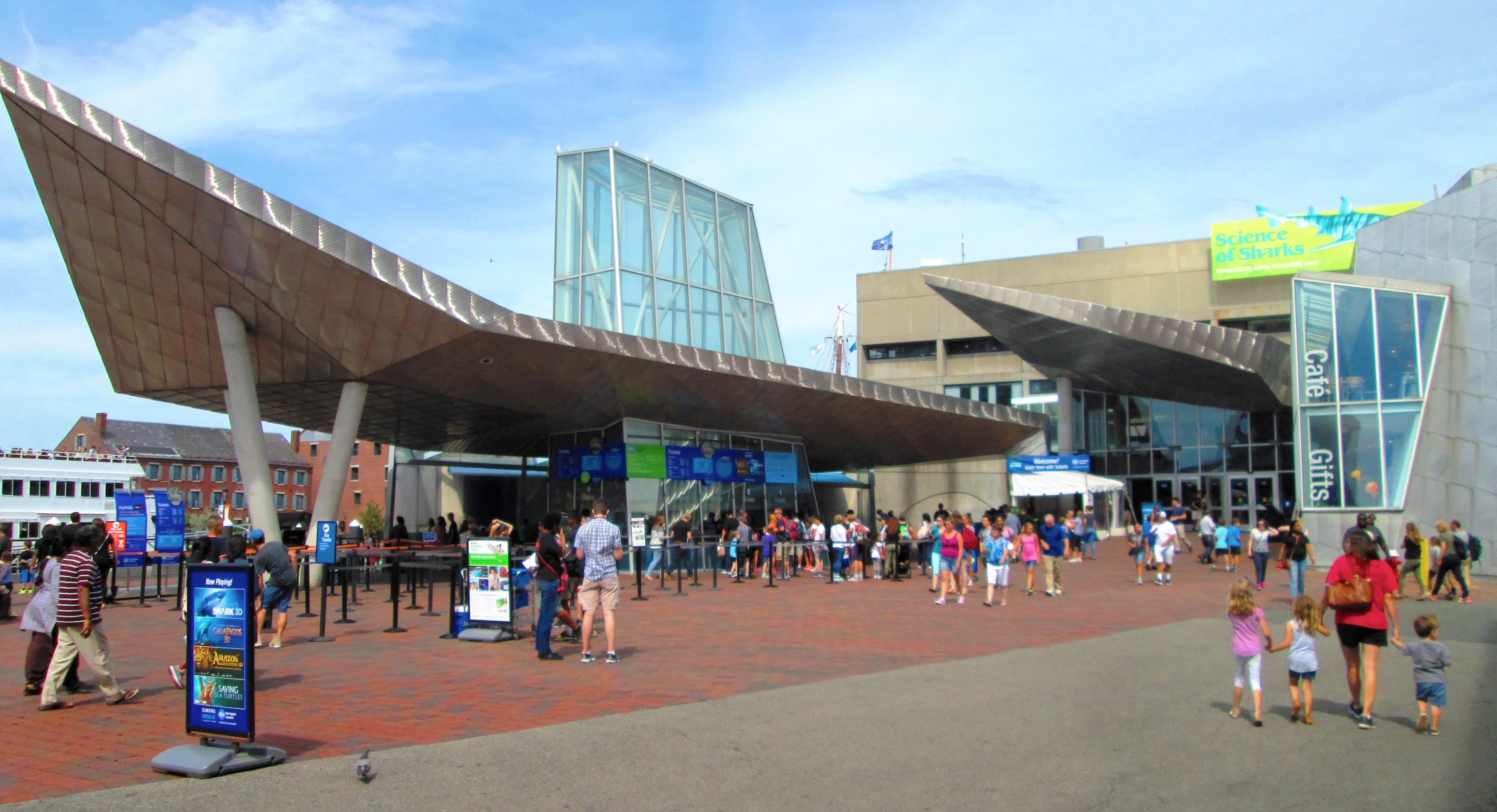 The New England Aquarium from the southwest, photographed August 11, 2017 — the main building on Central Wharf with the Simons Theatre beside it.