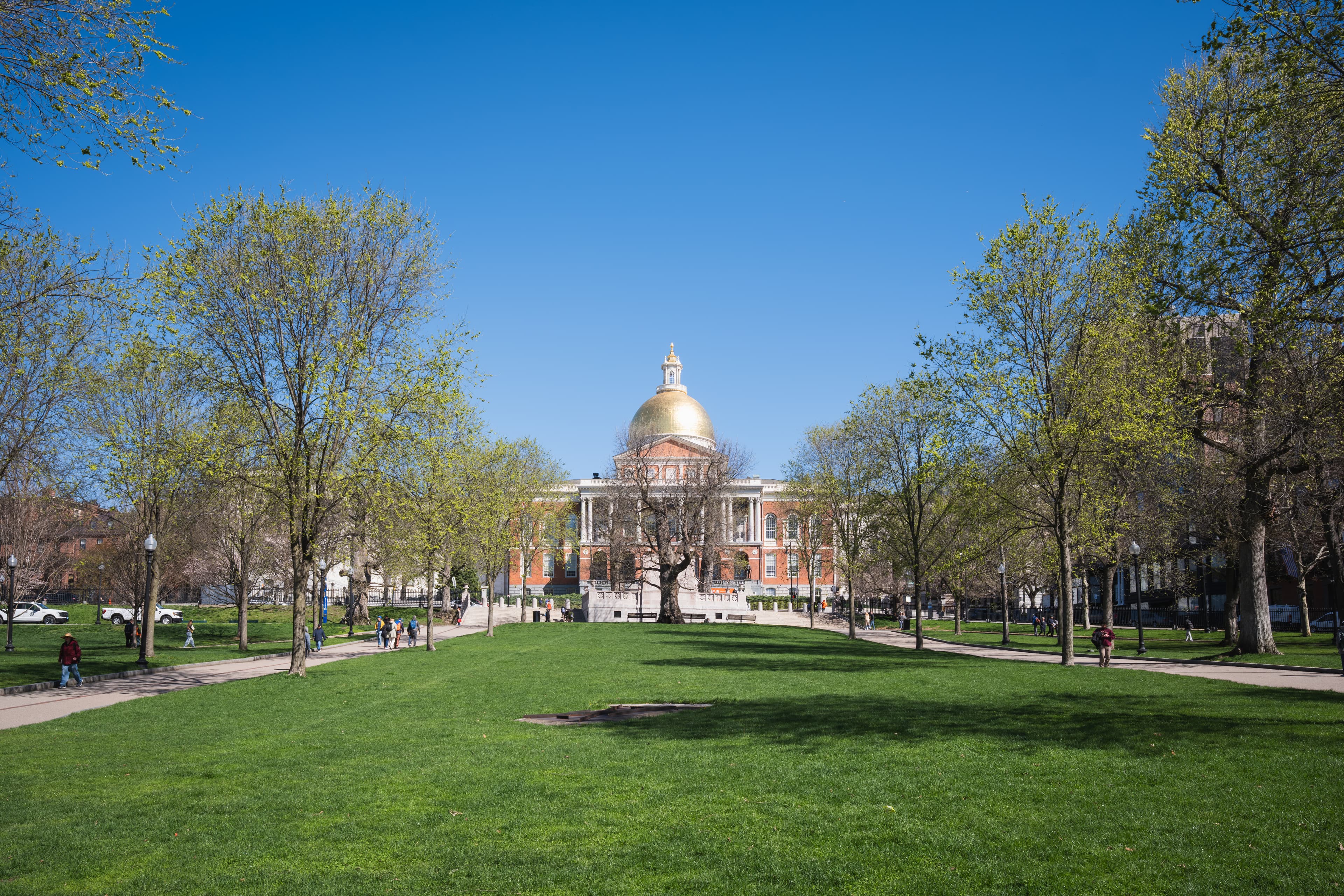 The golden-domed Massachusetts State House viewed across the lawn of Boston Common, where the Freedom Trail begins