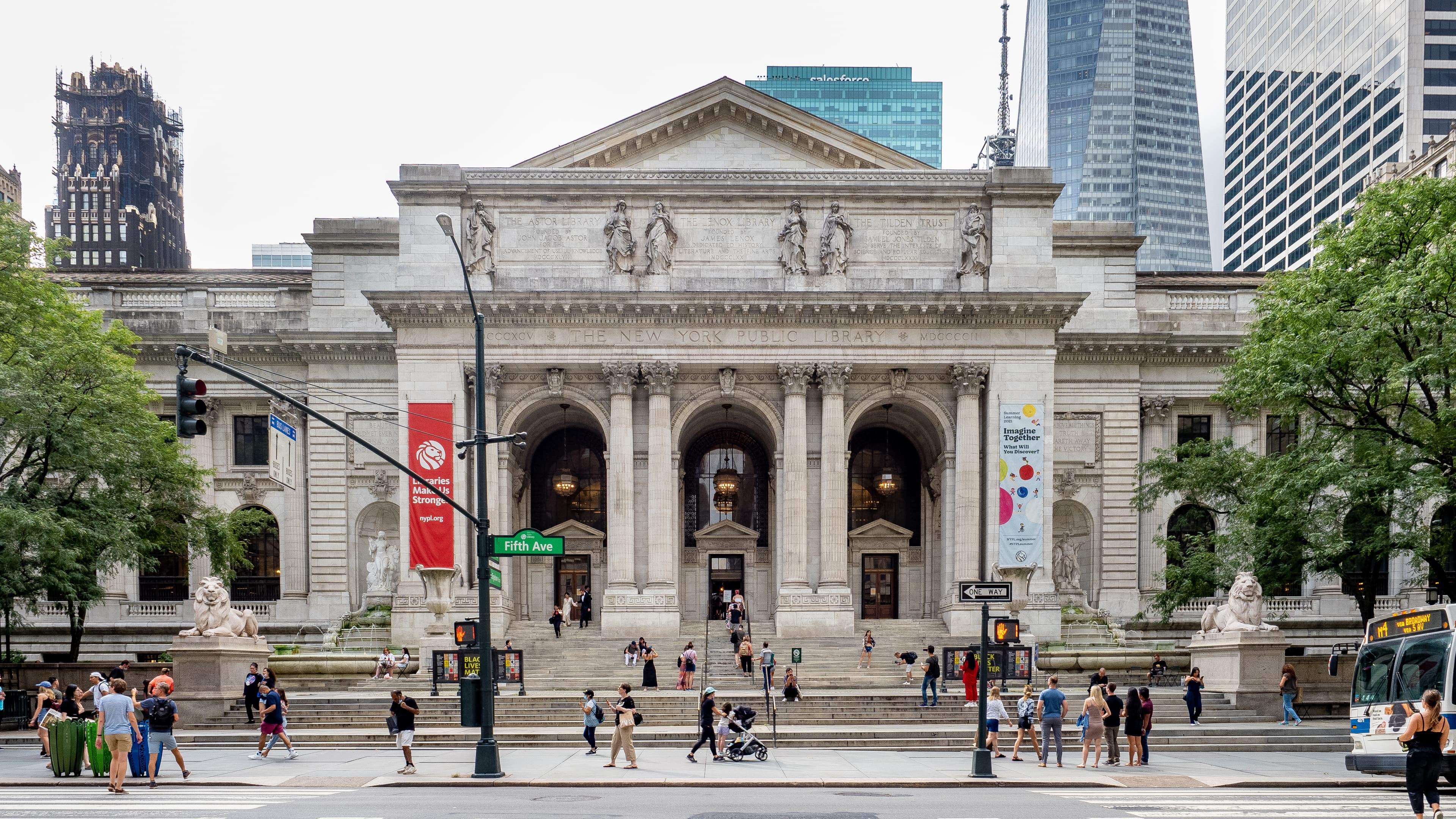 The Main Branch facade on Fifth Avenue, photographed August 21, 2021, with camera location at the library — a straight-on exterior view of the building's Fifth Avenue front. Hero photo: Ajay Suresh, CC BY 2.0, via Wikimedia Commons.