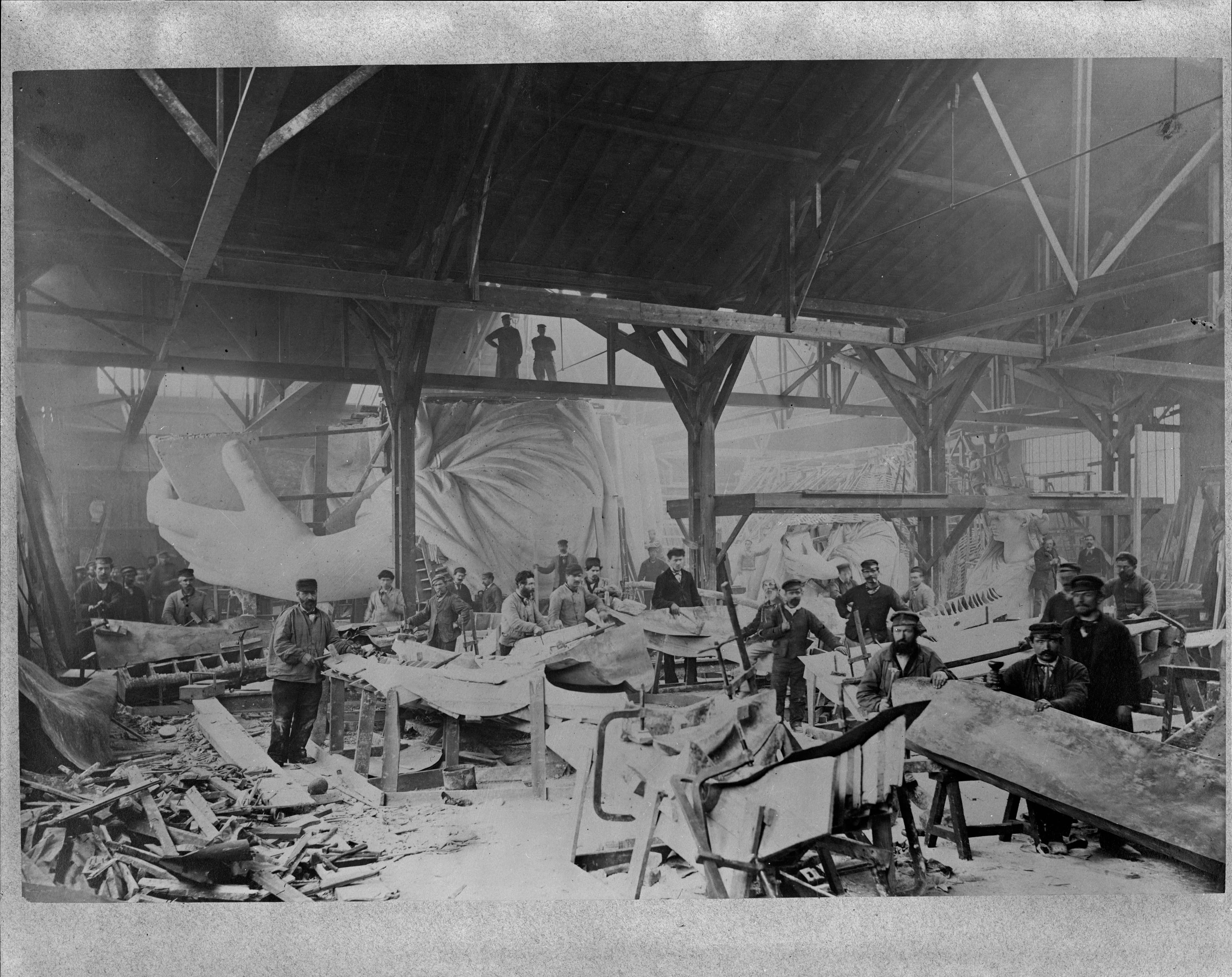 Workmen hammering the copper skin of the Statue of Liberty in Bartholdi's Paris workshop, winter 1882-83