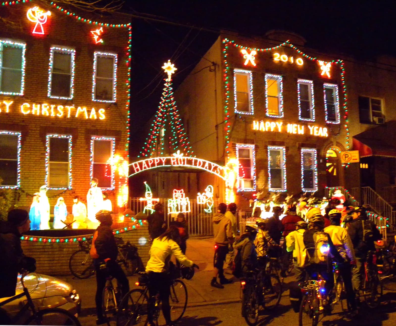 Visitors with bicycles outside a Dyker Heights house decorated with Christmas lights, December 2009